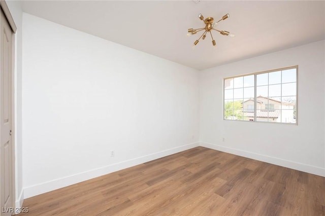 empty room featuring baseboards and light wood-style floors