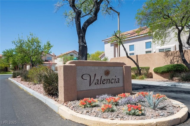 community / neighborhood sign with fence and a residential view