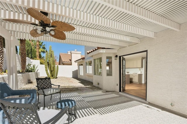 view of patio with fence, a pergola, and ceiling fan