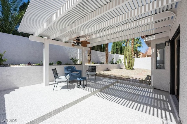 view of patio featuring a pergola, ceiling fan, outdoor lounge area, and a fenced backyard
