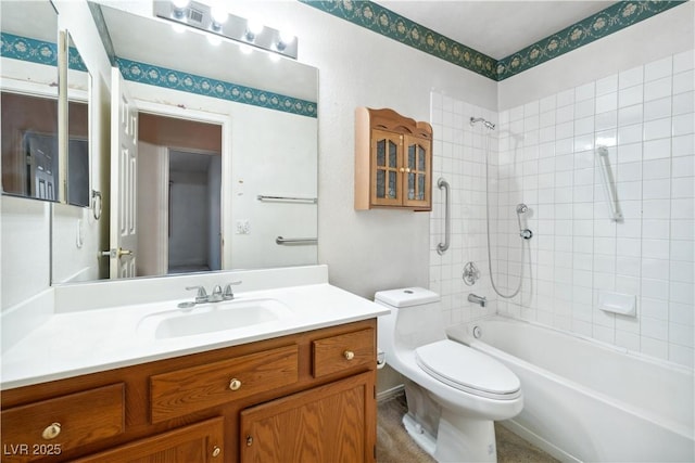 bathroom featuring shower / bath combination, vanity, and toilet
