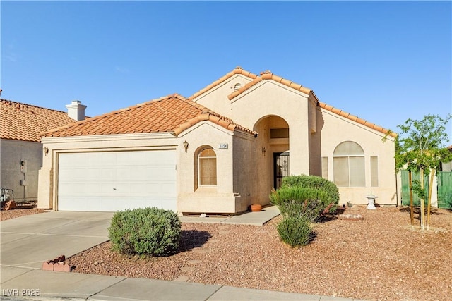 mediterranean / spanish-style home featuring stucco siding, a tiled roof, driveway, and a garage
