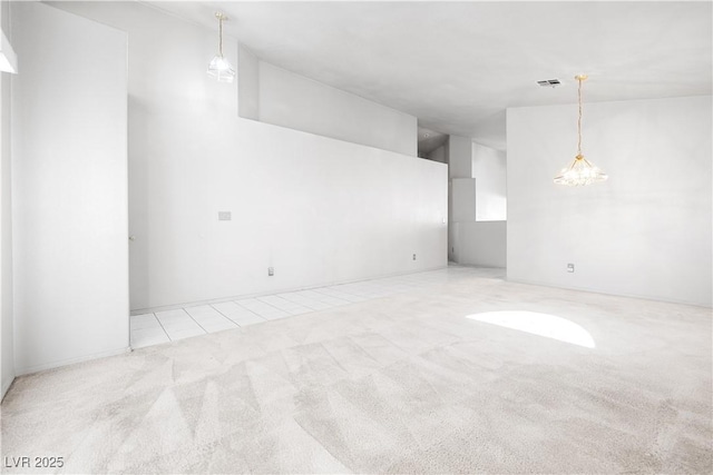 carpeted spare room featuring visible vents