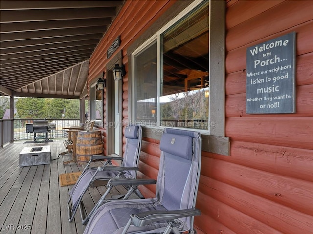 wooden terrace featuring a grill