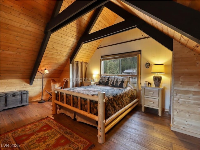 bedroom with lofted ceiling with beams, wood walls, and hardwood / wood-style floors