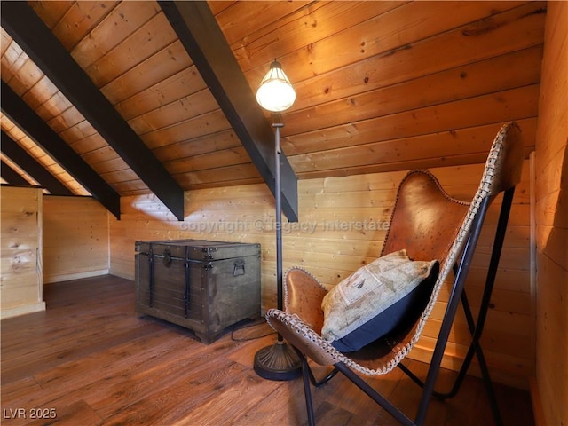 living area featuring lofted ceiling with beams, wooden walls, hardwood / wood-style floors, and wooden ceiling
