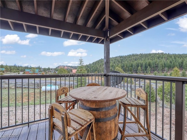 balcony featuring a view of trees