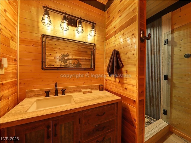 full bath featuring vanity, wooden walls, and a shower stall