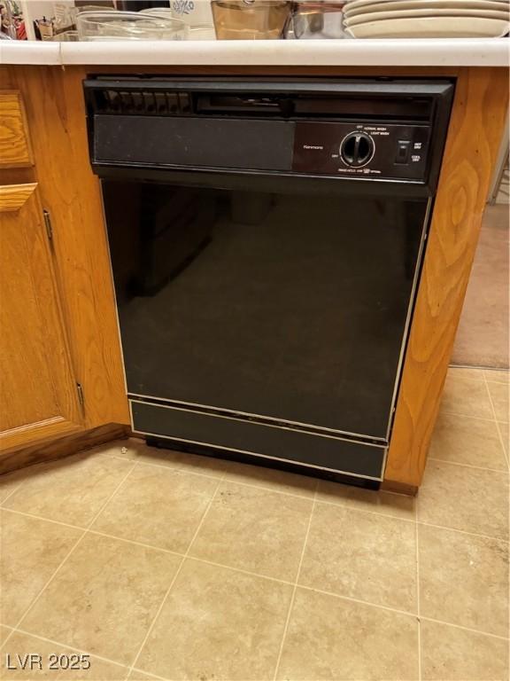 kitchen view of brown cabinets and black dishwasher