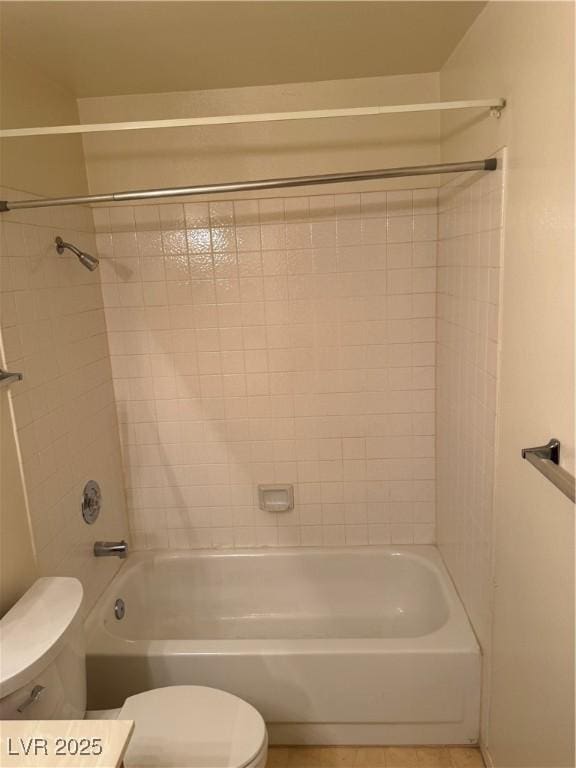 bathroom with toilet, tile patterned flooring, and shower / bathtub combination