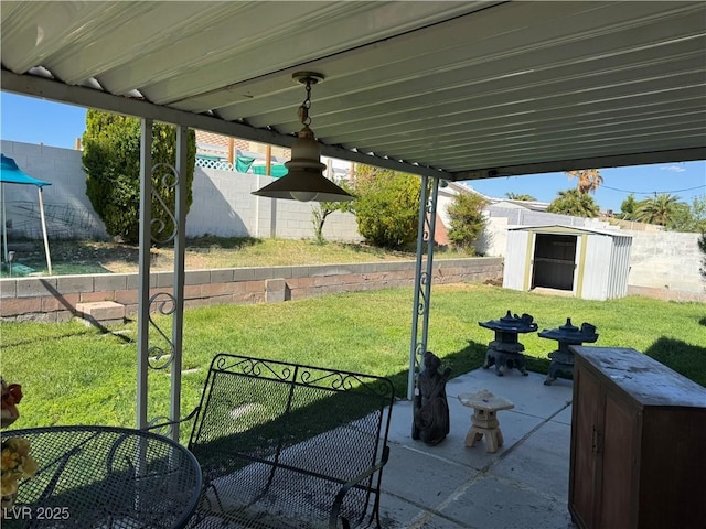 view of yard featuring a patio, a shed, and an outdoor structure