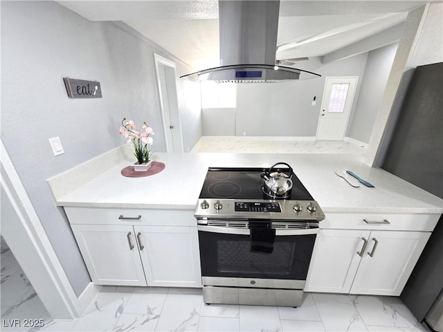 kitchen with island range hood, appliances with stainless steel finishes, baseboards, white cabinets, and marble finish floor