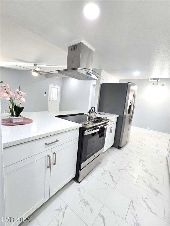 kitchen with appliances with stainless steel finishes, range hood, ceiling fan, and marble finish floor