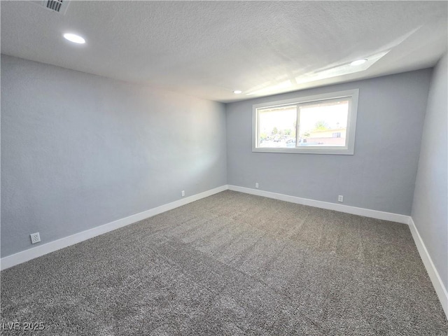 carpeted empty room featuring recessed lighting, a textured ceiling, visible vents, and baseboards