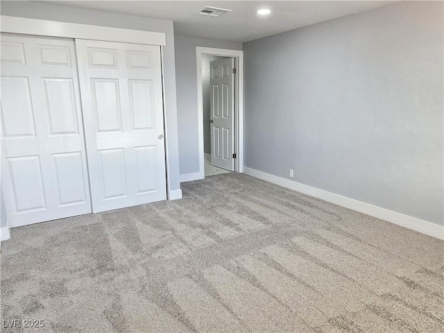 unfurnished bedroom with visible vents, a closet, baseboards, recessed lighting, and carpet flooring