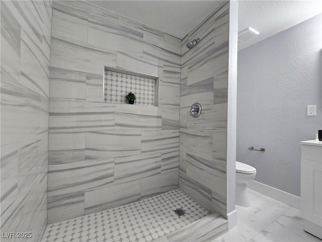full bath featuring baseboards, marble finish floor, toilet, and tiled shower