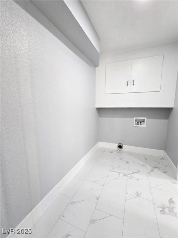 washroom featuring cabinet space, baseboards, marble finish floor, and hookup for a washing machine