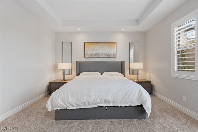 carpeted bedroom with recessed lighting, baseboards, and a tray ceiling