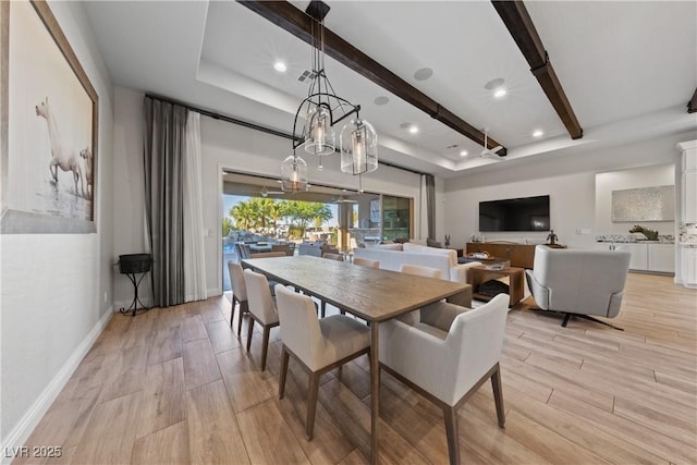 dining space with recessed lighting, a raised ceiling, baseboards, and light wood-type flooring