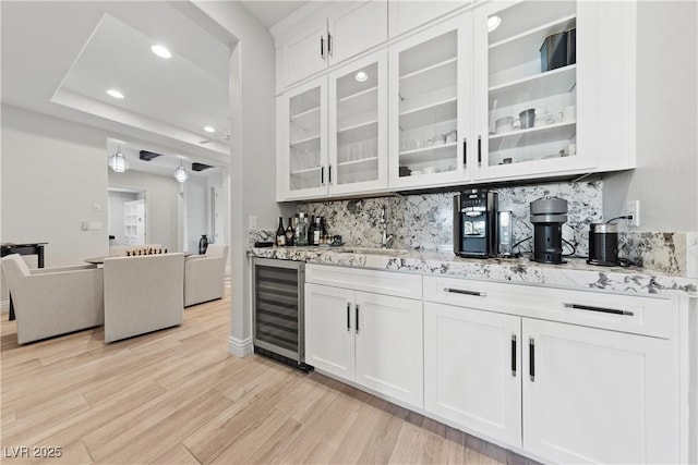 bar featuring beverage cooler, recessed lighting, a sink, and tasteful backsplash