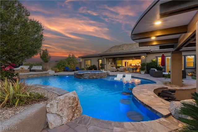view of swimming pool featuring a patio, a pool with connected hot tub, and an outdoor hangout area