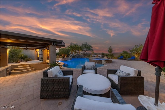 view of patio with ceiling fan, a pool with connected hot tub, and an outdoor hangout area
