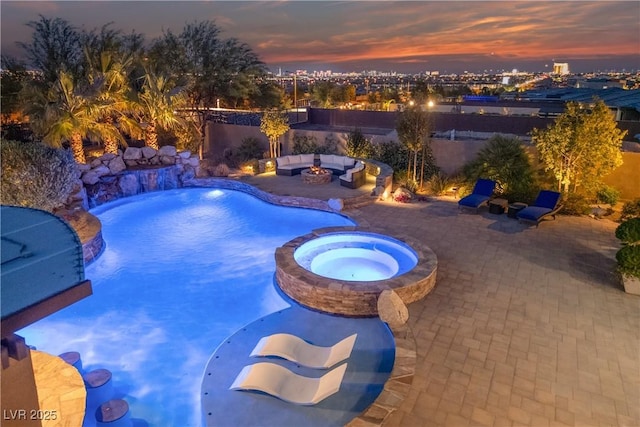 view of swimming pool with a fenced backyard, a patio, and a pool with connected hot tub