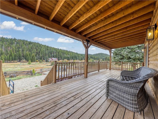 wooden deck featuring a forest view
