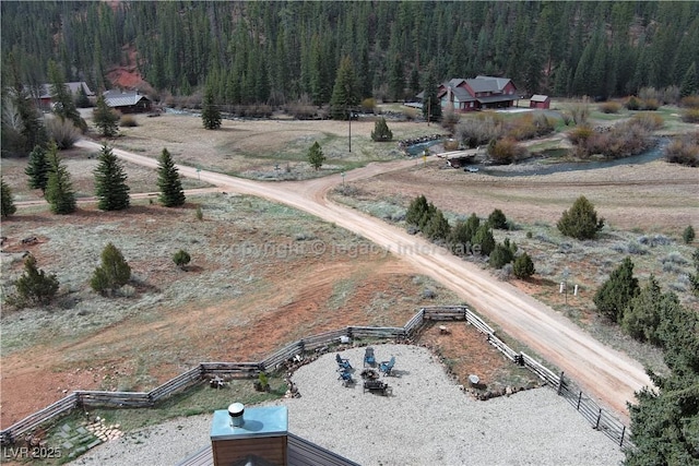 bird's eye view featuring a wooded view