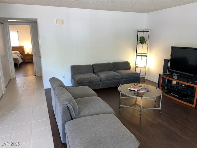 living room with baseboards and wood finished floors