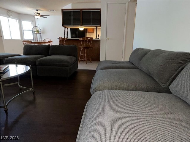living room with visible vents and a ceiling fan