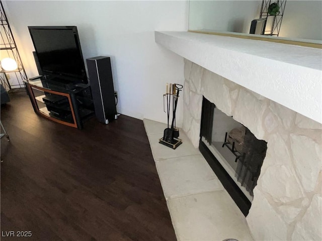 living area with a fireplace and wood finished floors