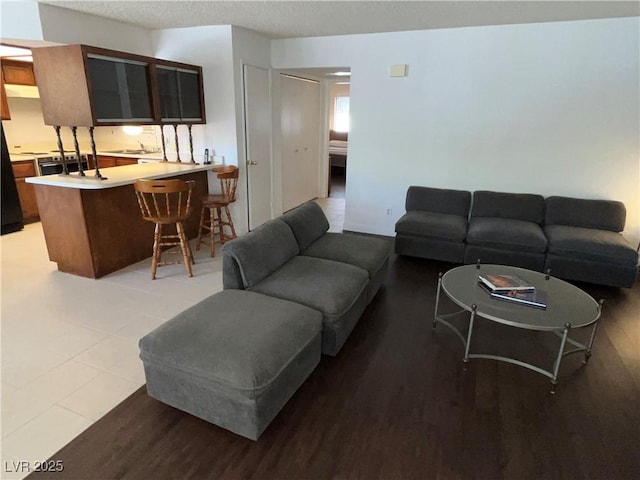 living room featuring light wood-style flooring and a textured ceiling