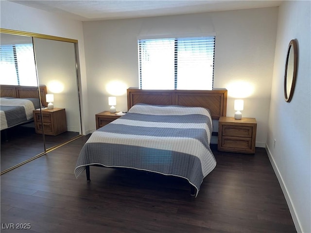 bedroom with a closet, baseboards, and wood finished floors