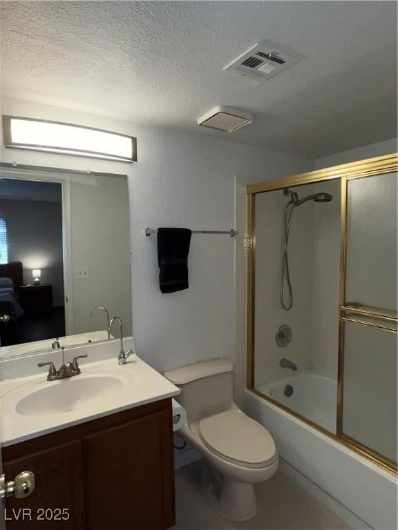 full bath with visible vents, vanity, toilet, a textured ceiling, and combined bath / shower with glass door
