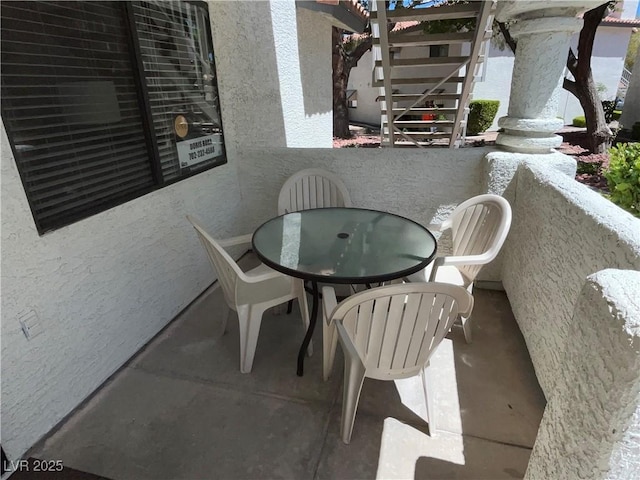 2704 Otter Creek Ct Unit 101, Las Vegas, NV 89117 - balcony featuring outdoor dining space and stairway