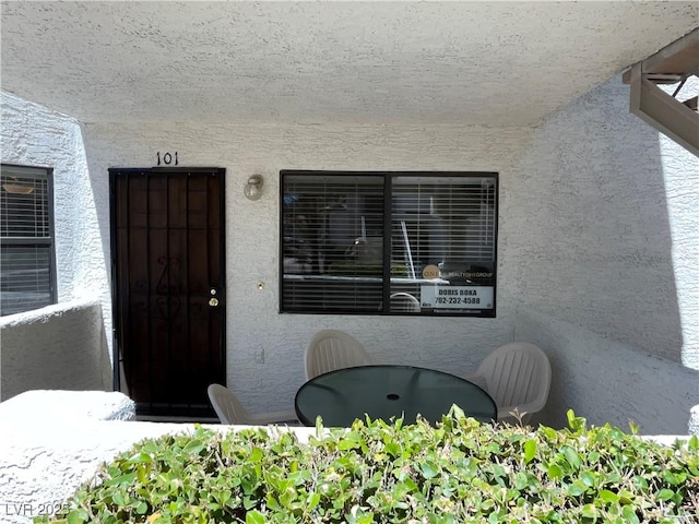 view of exterior entry with stucco siding