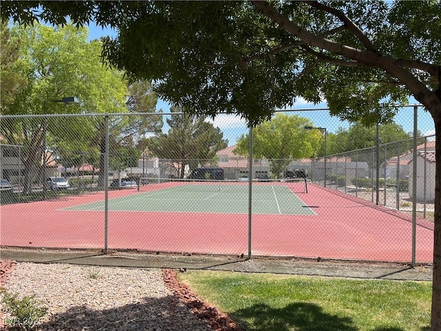 view of tennis court featuring fence