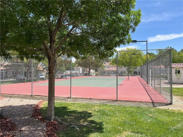 view of tennis court with fence