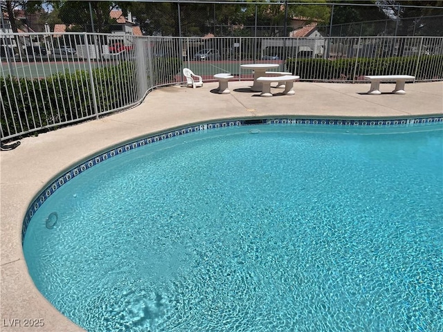 pool featuring fence and a patio area
