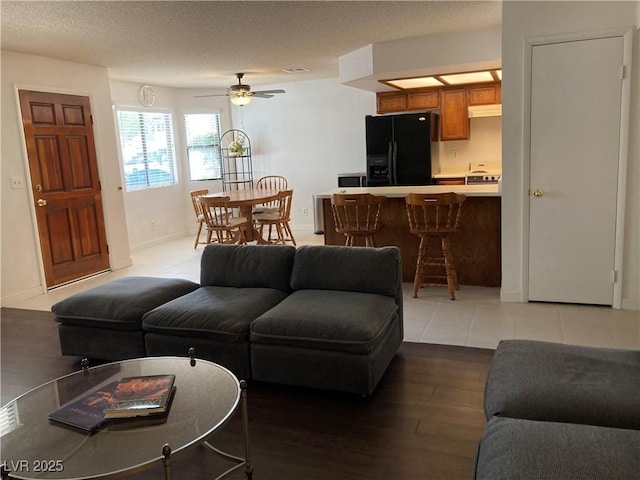2704 Otter Creek Ct Unit 101, Las Vegas, NV 89117 - living area with light wood-style floors, ceiling fan, and baseboards