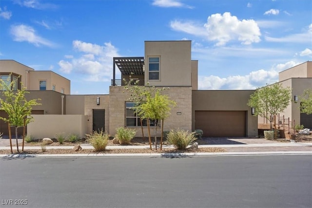 view of front of property featuring an attached garage, driveway, and stucco siding