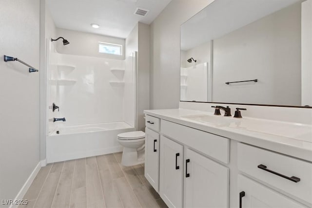 full bathroom featuring shower / bathing tub combination, visible vents, wood finished floors, vanity, and toilet