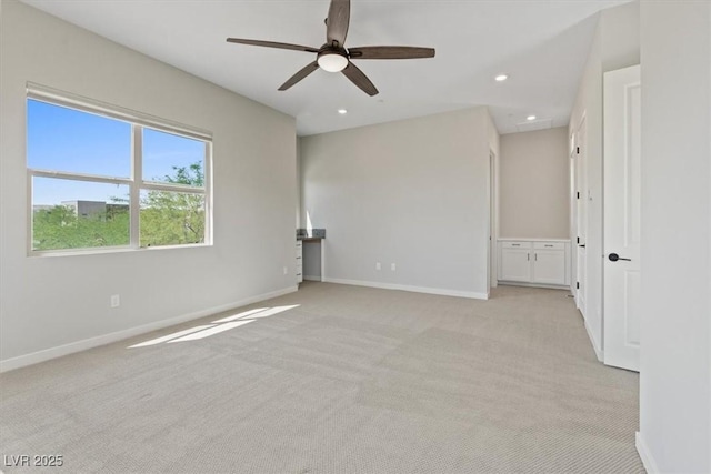 unfurnished room featuring light colored carpet, recessed lighting, baseboards, and a ceiling fan