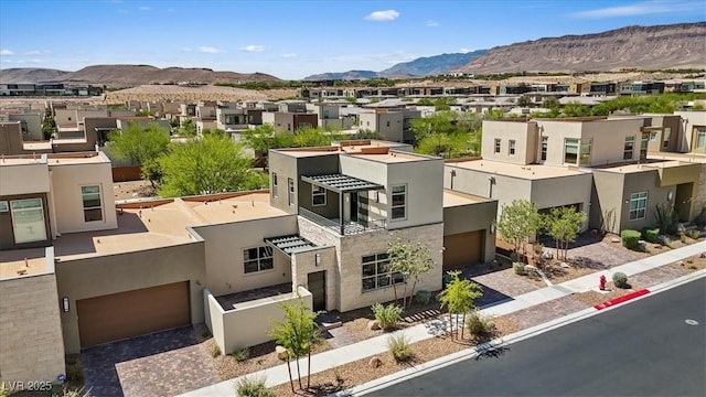 drone / aerial view featuring a residential view and a mountain view