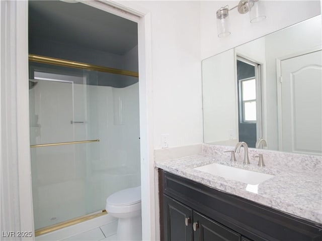 full bath featuring toilet, tile patterned floors, a shower stall, and vanity