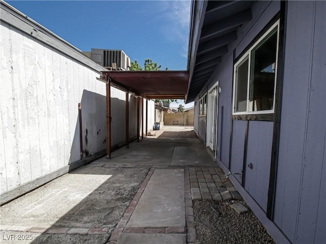 view of property exterior featuring a fenced backyard, central AC unit, and a patio area