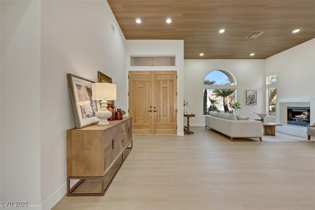 corridor with visible vents, recessed lighting, light wood-style flooring, and wooden ceiling