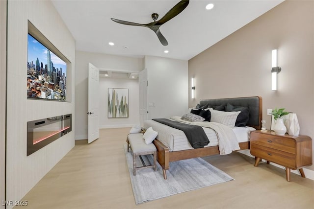 bedroom with recessed lighting, a ceiling fan, light wood finished floors, and baseboards