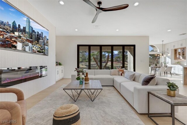 living room featuring recessed lighting, ceiling fan, and visible vents